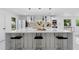 Bright kitchen featuring a large island with seating, modern appliances, and stylish pendant lighting at 305 Sweetwater Club Cir, Longwood, FL 32779