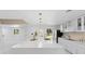 Bright kitchen featuring a large island with seating, modern appliances, and stylish pendant lighting at 305 Sweetwater Club Cir, Longwood, FL 32779