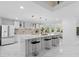 Bright kitchen featuring a large island with seating, modern appliances, and stylish pendant lighting at 305 Sweetwater Club Cir, Longwood, FL 32779