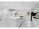 Spacious white kitchen with a large island, stainless steel appliances and modern fixtures at 305 Sweetwater Club Cir, Longwood, FL 32779