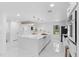 Spacious white kitchen featuring a large island, stainless steel appliances and brass fixtures at 305 Sweetwater Club Cir, Longwood, FL 32779