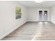 Bright room featuring neutral walls, light wood floors, a window and double doors for natural light at 305 Sweetwater Club Cir, Longwood, FL 32779