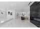 Bright, open living space featuring sleek marble floors and modern accents with a black marble fireplace at 305 Sweetwater Club Cir, Longwood, FL 32779
