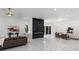 Open-concept living area featuring a modern fireplace, marble floors, and ample seating at 305 Sweetwater Club Cir, Longwood, FL 32779
