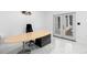 Bright office space with modern desk, chair, and double doors leading to the outside at 305 Sweetwater Club Cir, Longwood, FL 32779