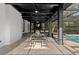 Covered outdoor space features a dining area, bar seating, and views of the inviting swimming pool at 305 Sweetwater Club Cir, Longwood, FL 32779