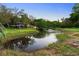 Lush backyard pond with fountain feature and a small two-story structure for relaxing at 305 Sweetwater Club Cir, Longwood, FL 32779