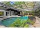 Stunning swimming pool with lush tropical landscaping and a screened enclosure for year-round enjoyment at 305 Sweetwater Club Cir, Longwood, FL 32779