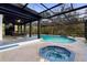 A beautiful in-ground swimming pool and hot tub are enclosed in a screened-in lanai, with outdoor seating and a waterfall feature at 305 Sweetwater Club Cir, Longwood, FL 32779