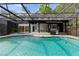 The screened-in pool area includes a dining area, outdoor kitchen, and a relaxing spa at 305 Sweetwater Club Cir, Longwood, FL 32779