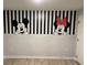Charming room with black and white stripes, faux brick, and Mickey Mouse and Minnie Mouse painted on the wall at 3397 Tranquil Trl, Kissimmee, FL 34747