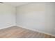 Clean, neutral-toned room featuring light wood flooring and ample wall space at 3397 Tranquil Trl, Kissimmee, FL 34747