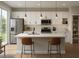 Modern kitchen with stainless steel appliances, a large island, pendant lighting, and herringbone backsplash at 3553 Sw 157Th Loop, Ocala, FL 34473
