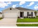 Charming single-story home featuring a two-car garage, well-maintained lawn, and classic curb appeal at 640 Royal Palm Dr, Dundee, FL 33838