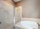 A standalone shower and soaking tub combination with tile surround, and glass enclosure at 728 Greybull Run, Lake Mary, FL 32746