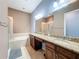 Elegant bathroom featuring a double vanity with granite counters, soaking tub, and walk-in glass shower at 728 Greybull Run, Lake Mary, FL 32746