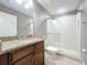 Bathroom featuring granite vanity, a frameless glass shower, and a neutral color scheme at 728 Greybull Run, Lake Mary, FL 32746