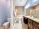 Bright bathroom boasts double sink vanity, soaking tub, granite countertops, and a glass-enclosed shower at 728 Greybull Run, Lake Mary, FL 32746