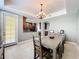 Dining area with chandelier, connecting to the kitchen, and lots of natural light at 728 Greybull Run, Lake Mary, FL 32746