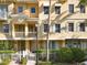 Charming townhome with white picket fence, front balcony and neutral stucco color at 728 Greybull Run, Lake Mary, FL 32746