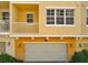 Exterior of a townhome featuring a garage, balcony, and warm, neutral paint at 728 Greybull Run, Lake Mary, FL 32746