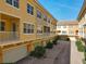 Exterior view of a townhome featuring a brick drive, garages, and neutral paint at 728 Greybull Run, Lake Mary, FL 32746
