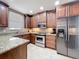 Well-lit kitchen featuring granite countertops, stainless steel appliances, and dark wood cabinetry at 728 Greybull Run, Lake Mary, FL 32746