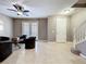 Inviting living area features tile flooring, neutral walls, ceiling fan, and staircase to the second floor at 728 Greybull Run, Lake Mary, FL 32746