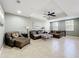 Spacious living room with tile floors, tray ceilings, ceiling fan, and an abundance of natural light at 728 Greybull Run, Lake Mary, FL 32746