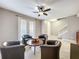 Cozy living room with tile flooring, ceiling fan, french doors, and stairway to the second floor at 728 Greybull Run, Lake Mary, FL 32746