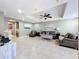 Expansive living area with tile floors, trey ceiling, ceiling fan, and views of the dining area and kitchen at 728 Greybull Run, Lake Mary, FL 32746