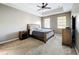 Spacious main bedroom with neutral carpet, ceiling fan, and an en-suite bath, perfect for relaxation at 728 Greybull Run, Lake Mary, FL 32746