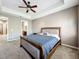 Cozy main bedroom boasting a ceiling fan, neutral walls and carpeting, with an ensuite bathroom at 728 Greybull Run, Lake Mary, FL 32746