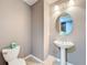 This powder room features a pedestal sink, decorative mirror, and light neutral paint at 728 Greybull Run, Lake Mary, FL 32746