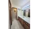 Clean bathroom with a long vanity, ample lighting, and tile flooring at 1016 Monroe Ave, St Cloud, FL 34769