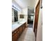 Bright bathroom featuring a long vanity, tile flooring, and access to the bedroom at 1016 Monroe Ave, St Cloud, FL 34769
