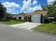 Street view of a charming single-story house with a well-maintained lawn and inviting curb appeal at 1016 Monroe Ave, St Cloud, FL 34769