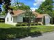 Quaint single-story home boasting a well-manicured lawn, mature trees, and an attached one-car garage at 1016 Monroe Ave, St Cloud, FL 34769