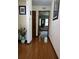 Well lit hall with hardwood floors leading to rooms and a closet at 1016 Monroe Ave, St Cloud, FL 34769