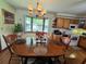 Well-lit kitchen and dining space with wood cabinets and a charming chandelier at 1016 Monroe Ave, St Cloud, FL 34769