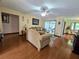 Cozy living room featuring hardwood floors, comfortable seating, and access to outdoor spaces at 1016 Monroe Ave, St Cloud, FL 34769