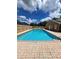 Community swimming pool with brick pavers and a bright blue sky and clouds at 1016 Monroe Ave, St Cloud, FL 34769