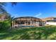 A well-manicured backyard with an enclosed pool, patio, and green lawn at 11314 Ledgement Ln, Windermere, FL 34786