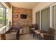An outdoor bar area with seating and a granite countertop by a sliding glass door at 11314 Ledgement Ln, Windermere, FL 34786