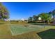 Community basketball court in a green space with well-maintained hoops near green grass and community playground at 11314 Ledgement Ln, Windermere, FL 34786