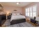 Serene bedroom with wood floors, a ceiling fan, plantation shutters, and tasteful decor at 11314 Ledgement Ln, Windermere, FL 34786