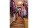 Walk-in closet with wood floors and custom shelving, perfect for organizing clothes and accessories at 11314 Ledgement Ln, Windermere, FL 34786