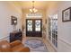 Welcoming foyer featuring a tiled floor, elegant double doors, neutral paint, and decorative lighting for a grand entrance at 11314 Ledgement Ln, Windermere, FL 34786