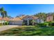 Charming single-story home with a three-car garage, manicured landscaping, and a tiled roof in a sunny neighborhood at 11314 Ledgement Ln, Windermere, FL 34786