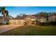 Charming single-story home with a well-manicured lawn, mature landscaping, and inviting curb appeal at 11314 Ledgement Ln, Windermere, FL 34786